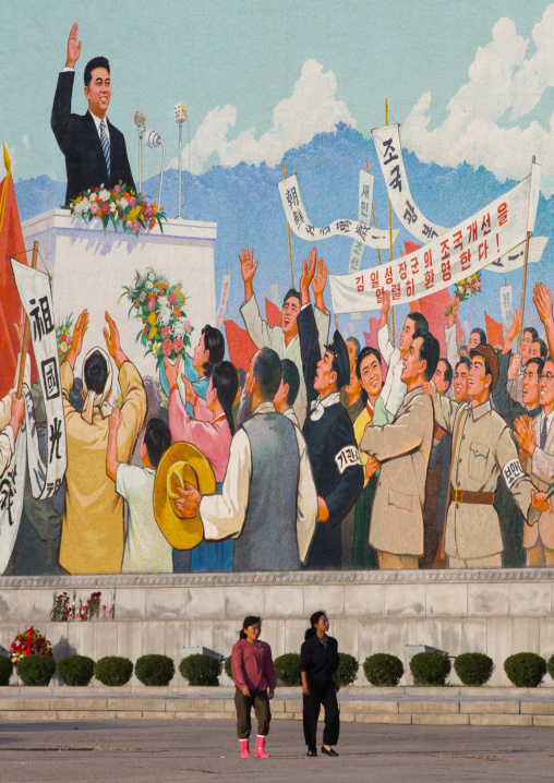 North Korean people passing in front of a giant Kim il Sung mosaic fresco, Pyongan Province, Pyongyang, North Korea