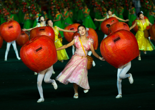 North Korean women dancing between apples during the Arirang mass games in may day stadium, Pyongan Province, Pyongyang, North Korea