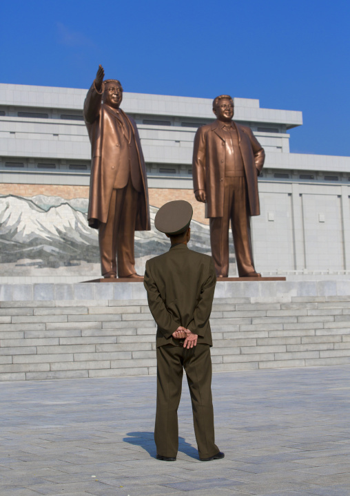 North kotrean soldier paying respect to the two statues of the Dear Leaders in the Grand monument on Mansu hill, Pyongan Province, Pyongyang, North Korea