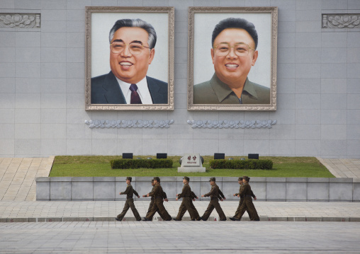 North Korean soldiers passing in front of Kim il Sung and Kim Jong il giant portraits on Kim il Sung square, Pyongan Province, Pyongyang, North Korea