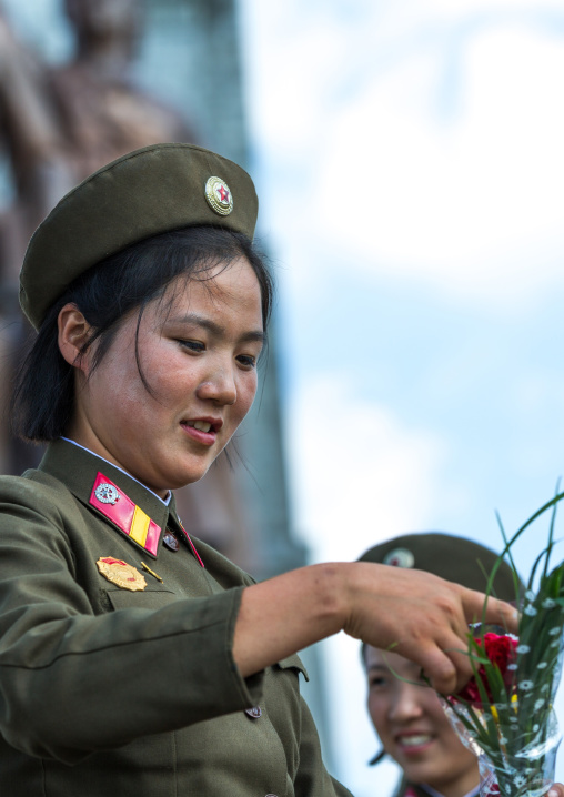 North Korean soldiers woman with flowers, Pyongan Province, Pyongyang, North Korea
