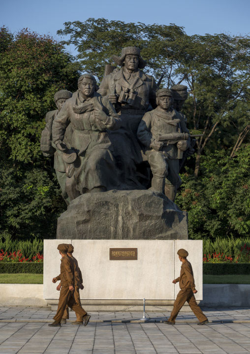North Korean soldiers passing in front of a monument to the victorious fatherland liberation war museum, Pyongan Province, Pyongyang, North Korea