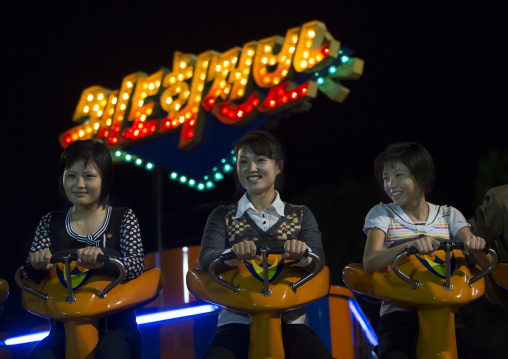 North Korean women in a fairground attraction at Kaeson youth park, Pyongan Province, Pyongyang, North Korea