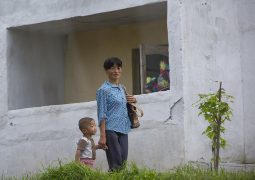 North Korean mother and child walking in the street, South Hamgyong Province, Hamhung, North Korea