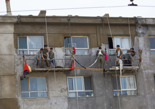 North Korean workmen on a dangerous scaffolding, South Hamgyong Province, Hamhung, North Korea
