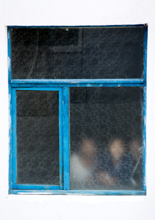 North Korean workers behind a window in Hungnam nitrogen fertilizer plant, South Hamgyong Province, Hamhung, North Korea