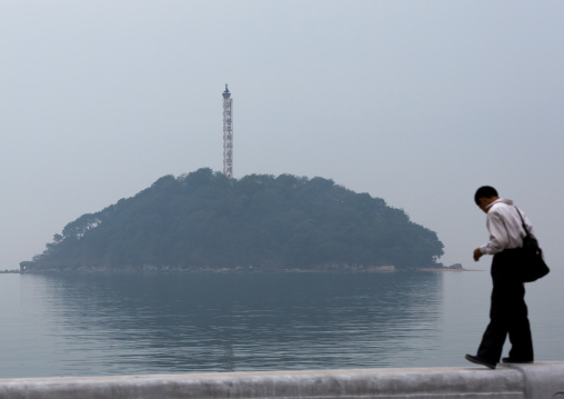 North Korean man in front of a small island, South Hamgyong Province, Hamhung, North Korea