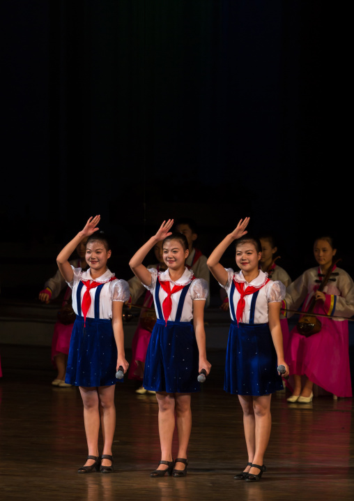 Young North Korean pioneers girls saluting during a show in Mangyongdae children's palace, Pyongan Province, Pyongyang, North Korea