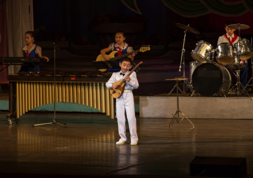 Young North Korean artist playing guitar during a show in Mangyongdae children's palace, Pyongan Province, Pyongyang, North Korea