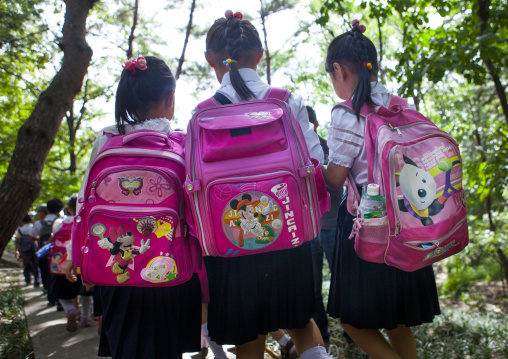 North Korean girls with Mickey bags on their backs going to school, Pyongan Province, Pyongyang, North Korea