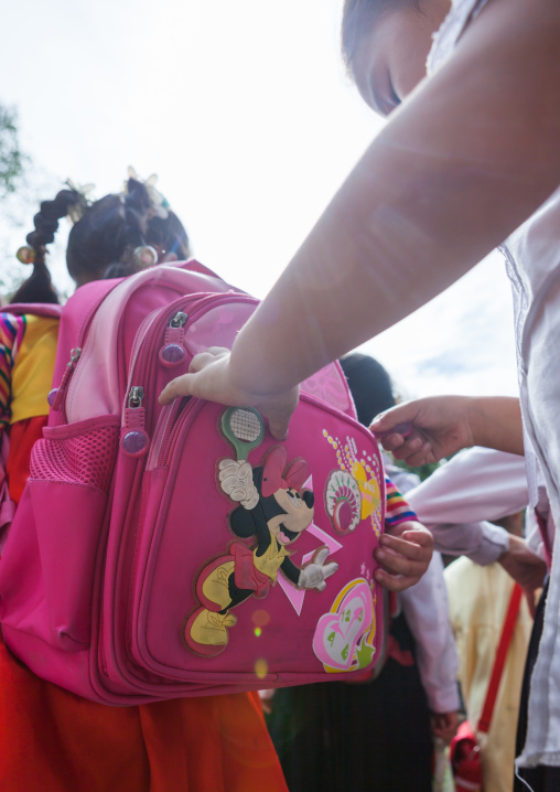 North Korean girl with Mickey bag on her back going to school, Pyongan Province, Pyongyang, North Korea