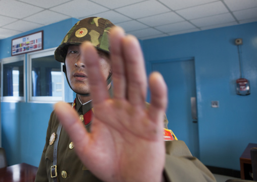 North Korean soldier refusing a picture in the conference room of the United Nations on the demarcation line in the Demilitarized Zone, North Hwanghae Province, Panmunjom, North Korea