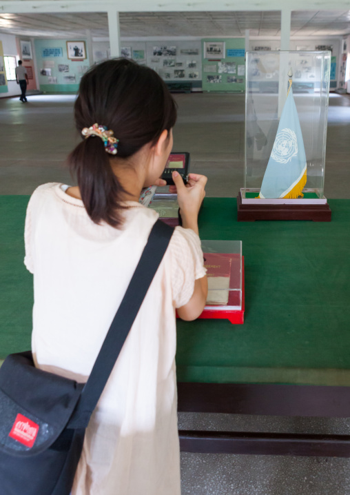 Tourist taking a picture of the armistice agreement in the North Korea peace museum, North Hwanghae Province, Panmunjom, North Korea