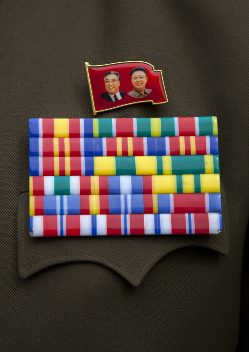 Dear Leaders badges and medals on an officer vest, North Hwanghae Province, Panmunjom, North Korea