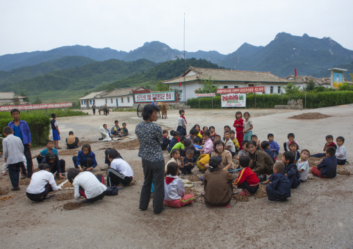 Children in a village sorting by hand the grain harvested, North Hwanghae Province, Kaesong, North Korea