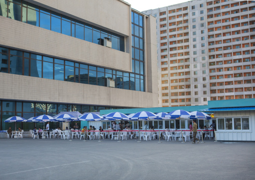 Cafe with umbrellas in the street in the middle of buildings, Pyongan Province, Pyongyang, North Korea