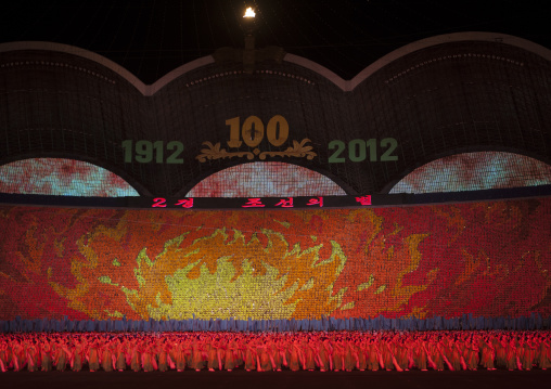 Flames made by children pixels holding up colored boards during Arirang mass games in may day stadium, Pyongan Province, Pyongyang, North Korea