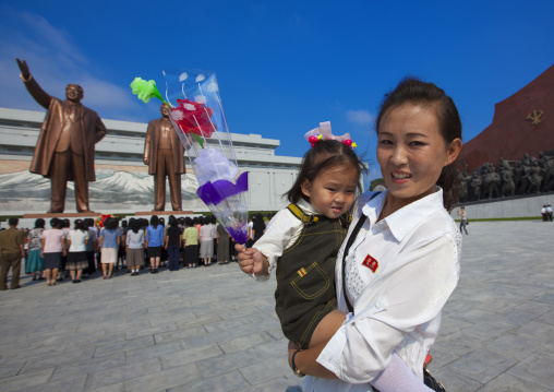 North Korean mother and daughter in front of the statues of the Dear Leaders in Mansudae Grand monument, Pyongan Province, Pyongyang, North Korea