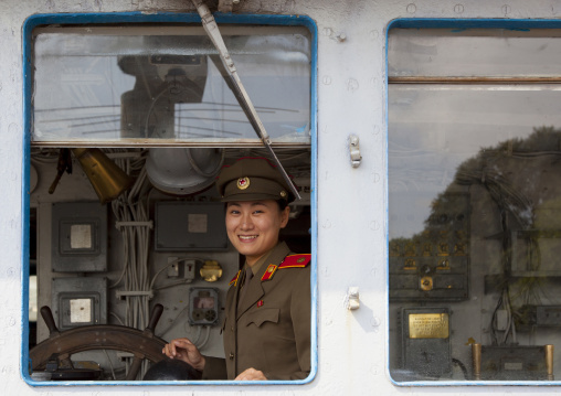 North Korean guide inside Uss Pueblo american spy boat looking thru the window, Pyongan Province, Pyongyang, North Korea