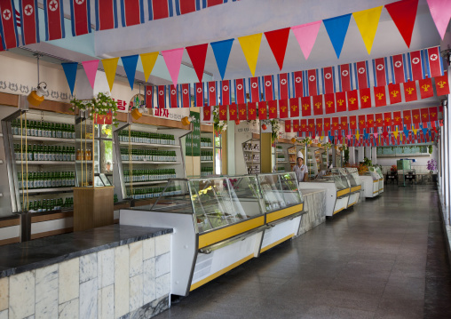 Shop with North Korean flags as decoration on national day, Pyongan Province, Pyongyang, North Korea