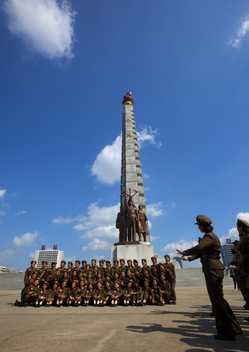 North Korean female soldiers posing in front of the Juche tower built to commemorate Kim il-sung's 70th birthday, Pyongan Province, Pyongyang, North Korea