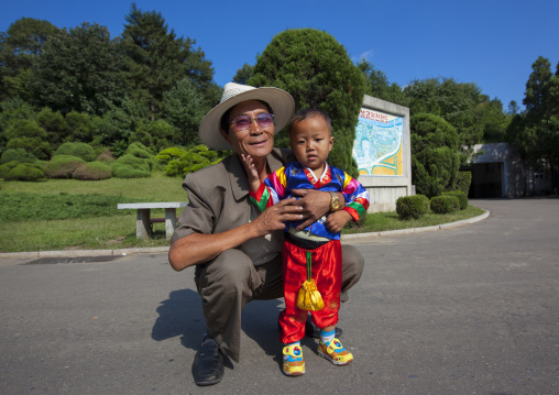 Portrait of a North Korean Grand father with his little one year old son, Pyongan Province, Pyongyang, North Korea