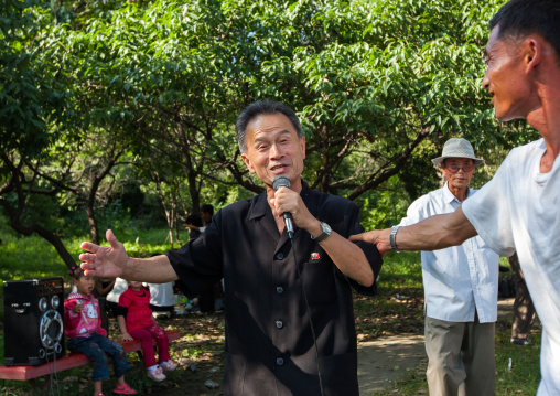 North Korean men singing in a park on national day, Pyongan Province, Pyongyang, North Korea