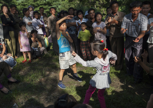 North Korean children dancing in a park on september 9 day of the foundation of the republic, Pyongan Province, Pyongyang, North Korea
