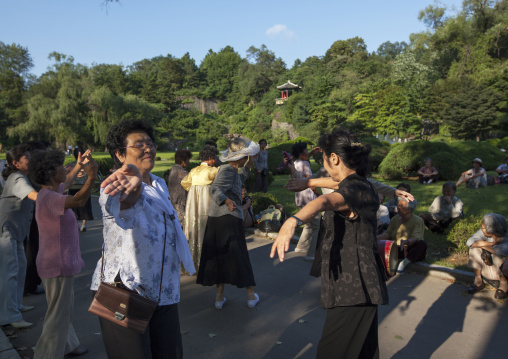 North Korean people dancing in a park on september 9 day of the foundation of the republic, Pyongan Province, Pyongyang, North Korea