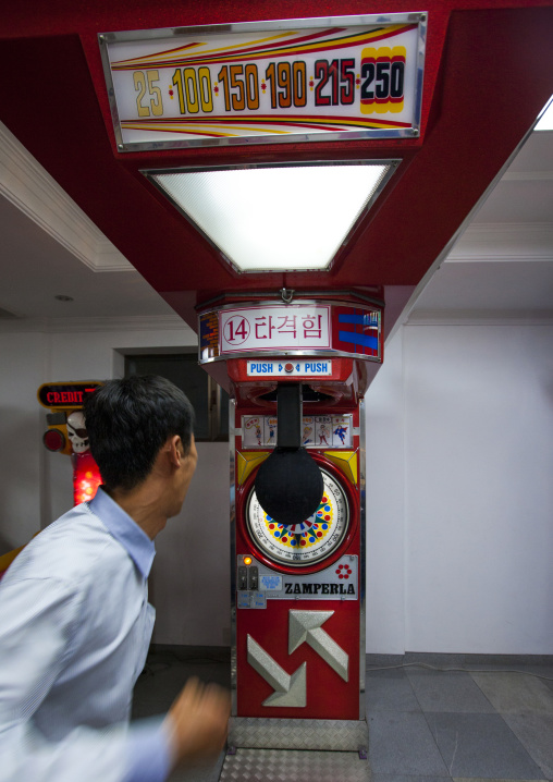 North Korean man beating a test your strength machine in Kaeson youth park, Pyongan Province, Pyongyang, North Korea