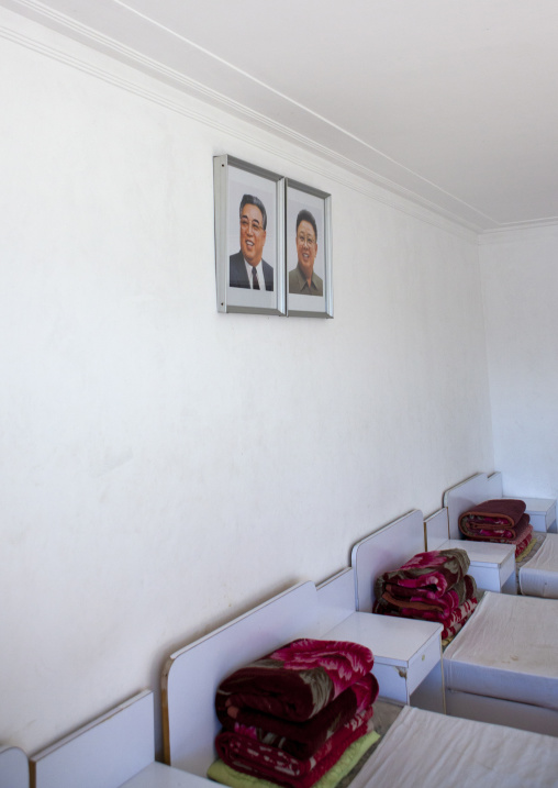 Bedroom with the official portraits of the Dear Leaders in Songdowon international children's camp, Kangwon Province, Wonsan, North Korea