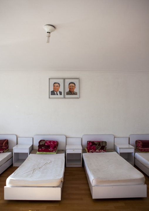 Bedroom with the official portraits of the Dear Leaders in Songdowon international children's camp, Kangwon Province, Wonsan, North Korea