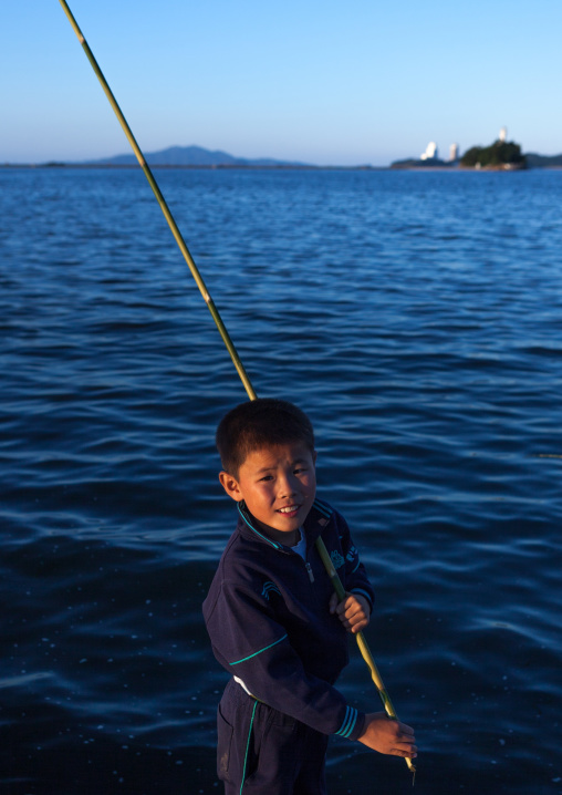 North Korean boy fishing in the port, Kangwon Province, Wonsan, North Korea