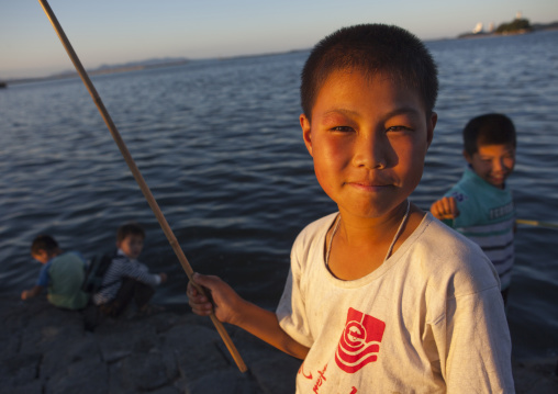 Portrait of a North Korean child boy fishing in the sea, Kangwon Province, Wonsan, North Korea