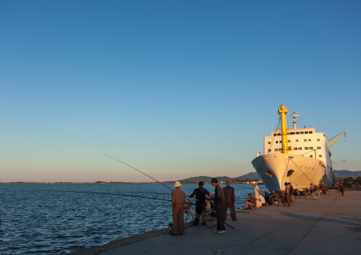 North Korean men fishing in front of a ship in the port, Kangwon Province, Wonsan, North Korea