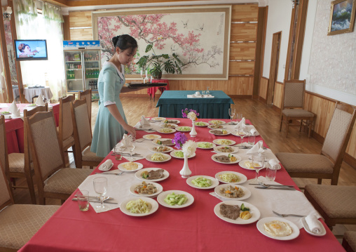 North Korean woman setting a table in a restaurant for tourists, South Hamgyong Province, Hamhung, North Korea