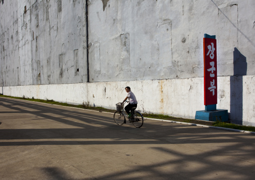 North Korean man riding a bicycle in Hungnam nitrogen fertilizer plant, South Hamgyong Province, Hamhung, North Korea