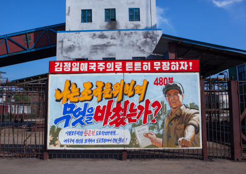 North Korean propaganda billboard at Hungnam nitrogen fertilizer plant saying let us arm ourselves solidly with Kim jong-il's patriotism!, South Hamgyong Province, Hamhung, North Korea