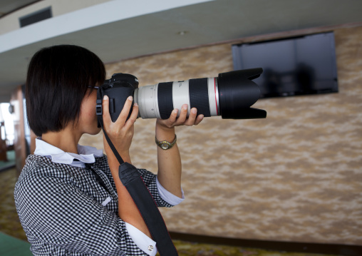 North Korean woman testing a professional camera, Pyongan Province, Pyongyang, North Korea