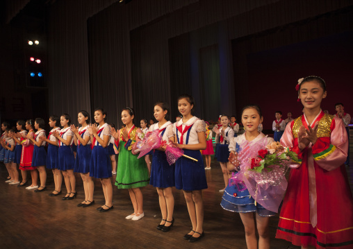 Young North Korean artists with flowers at the end of their show in Mangyongdae children's palace, Pyongan Province, Pyongyang, North Korea