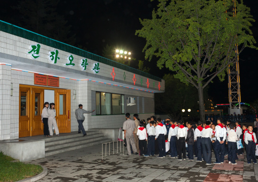 North Korean pioneers queueing to enter the video games center in Kaeson youth parkfun fair, Pyongan Province, Pyongyang, North Korea