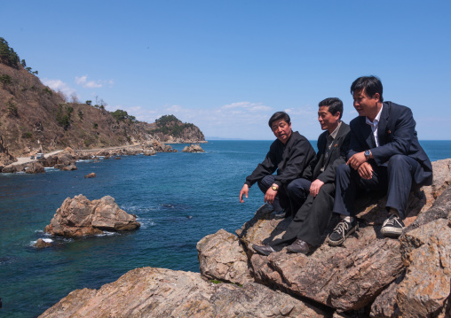North Korean guides having a pause in the rocky coastline, North Hamgyong Province, Chilbo Sea, North Korea