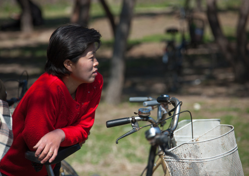 North Korean woman resting on her bicycle, North Hamgyong Province, Chilbo Sea, North Korea