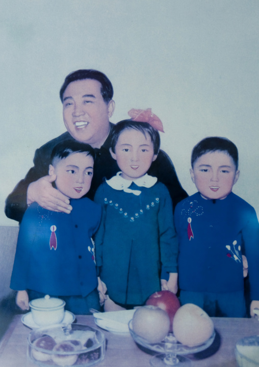 Kim il Sung with triplets on a propaganda poster in Tchang Gwang school, North Hamgyong Province, Chongjin, North Korea