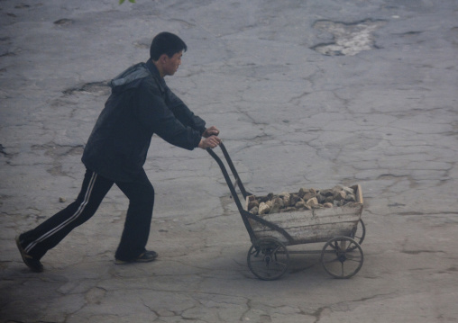 North Korean man pushing a cart full of stones, North Hamgyong Province, Chongjin, North Korea