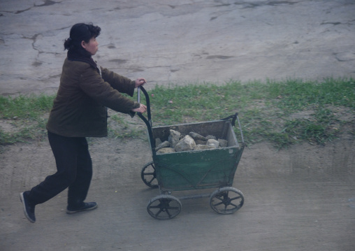 North Korean woman pushing a cart full of stones, North Hamgyong Province, Chongjin, North Korea