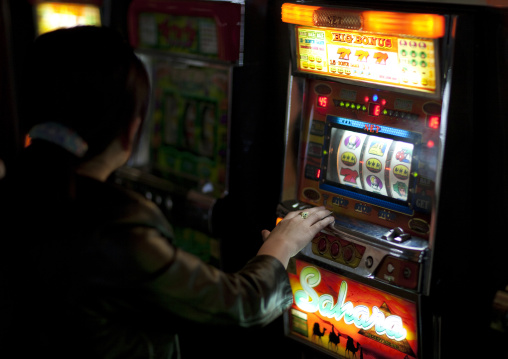 North Korean people playing slot machines in a casino, Pyongan Province, Pyongyang, North Korea