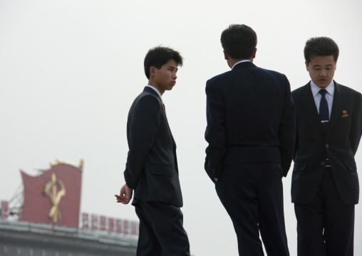 North Korean young men in black suits in Kim il Sung square, Pyongan Province, Pyongyang, North Korea