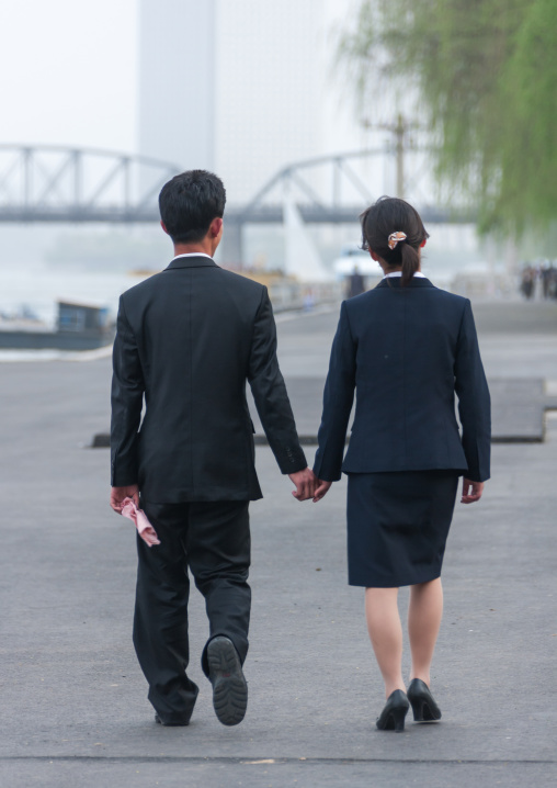 North Korean couple inlove walking hand in hand in the street, Pyongan Province, Pyongyang, North Korea