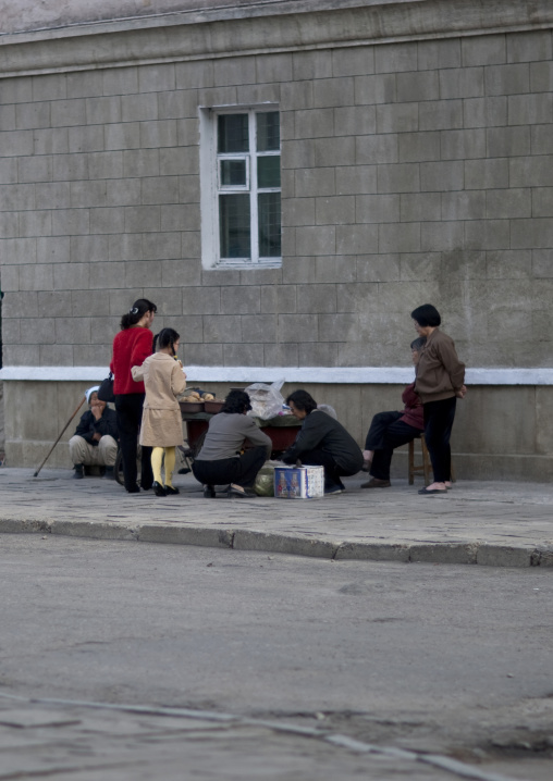 North Korean people buying food to street seller, Pyongan Province, Pyongyang, North Korea